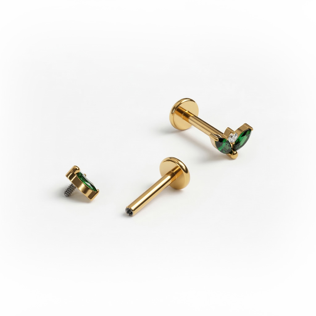 Tytanowy labret z parą szmaragdowych kamieni